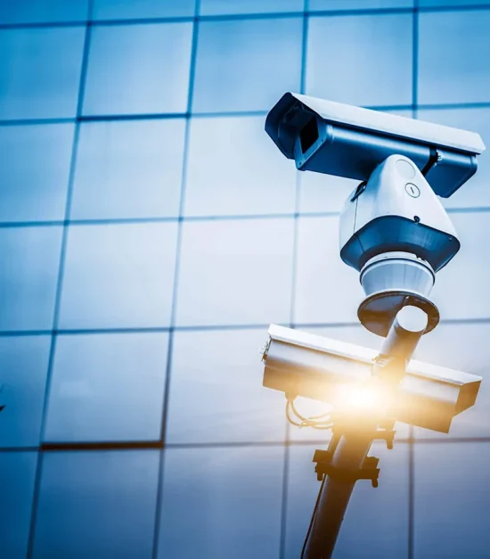 Security camera on modern glass building